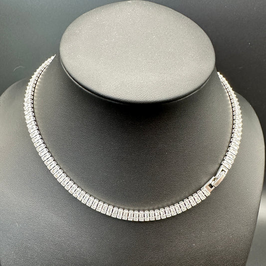 Silver necklace on a gray mannequin bust