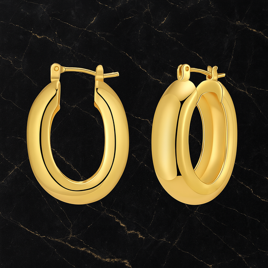 flat lay of two gold chunky earrings on black granite