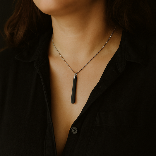 Wood Ebony Necklace with a pendant worn by a person against a dark background