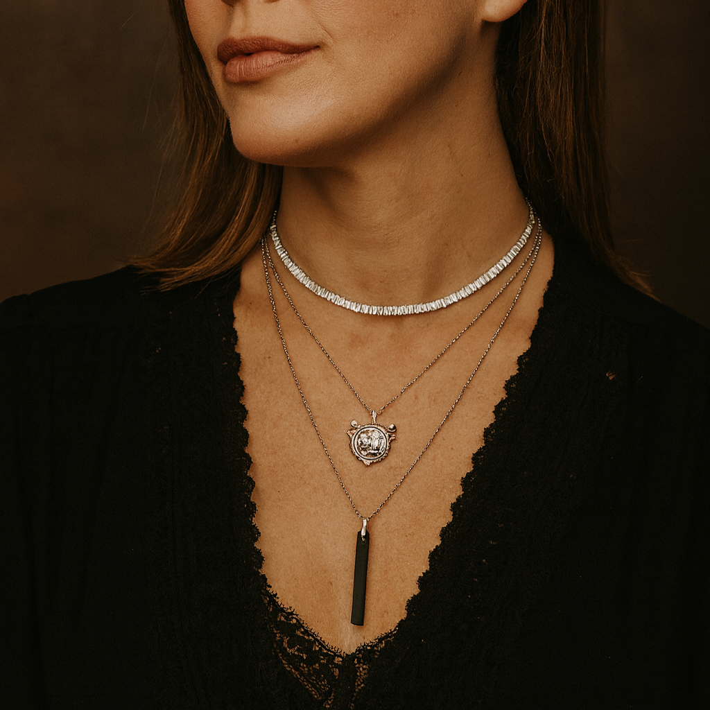 Woman wearing multiple necklaces against a brown background