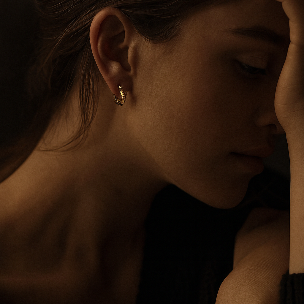 woman wearing petite bamboo style earrings. 
