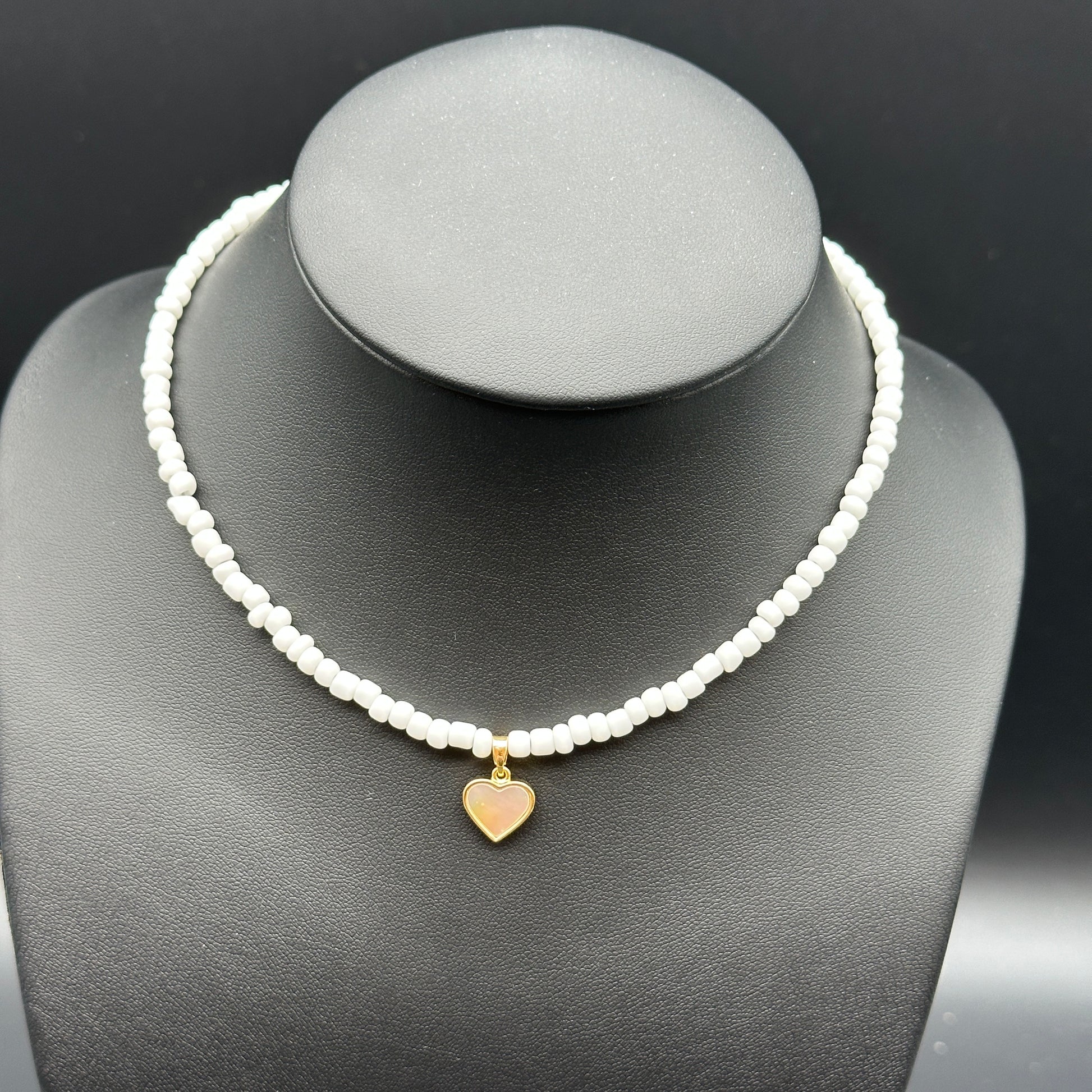 Necklace with white beaded chain and gold mother of pearl heart pendant 