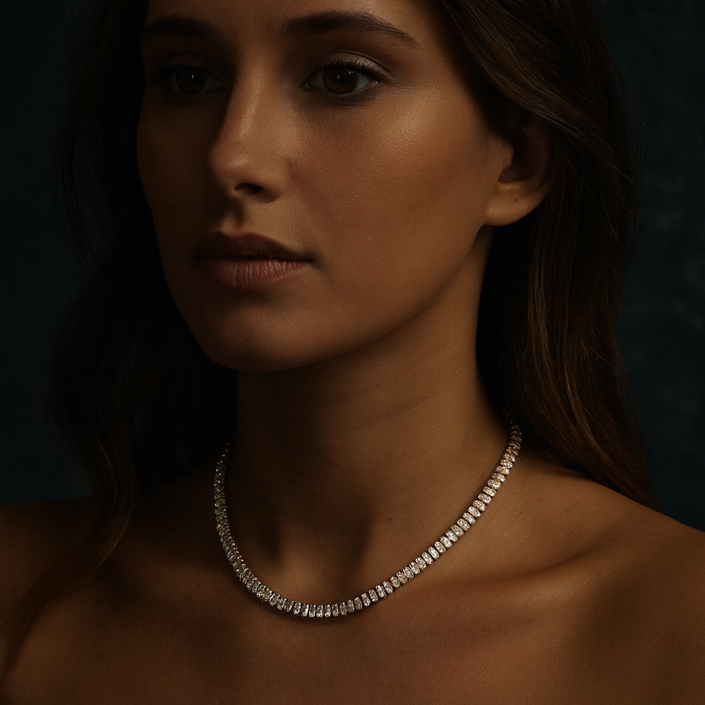 Young woman wearing a 16-inch 18K gold-plated baguette tennis necklace with cubic zirconia stones, dark moody background.